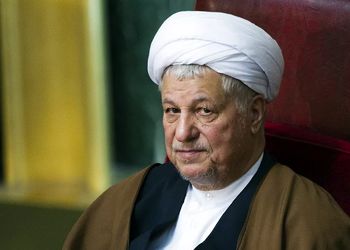 هاشمی رفسنجانی در حال خوراندن واکسن به یک کودک